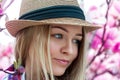 Cutie young blonde woman in hat looking away with flowers Royalty Free Stock Photo