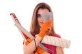 Cutie young brunette lady makes renovation in gloves with tools in her hands isolated on white background Royalty Free Stock Photo