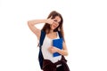 Cutie young brunette student with blue backpack on her shoulders posing isolated on white background Royalty Free Stock Photo