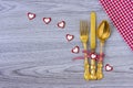 Cutlery with a bow, seven hearts and napkin