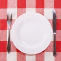 Cutlery on checkered tablecloth