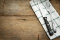 Cutlery and fork with napery on wooden background. Royalty Free Stock Photo