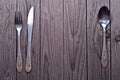 Cutlery kitchenware on old wooden boards background