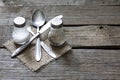 Cutlery kitchenware on old wooden boards background