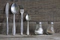 Cutlery kitchenware on old wooden boards background