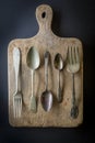 Cutlery kitchenware on old wooden boards