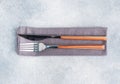 Cutlery knife and fork on a napkin  gray concrete background  copy space top view Royalty Free Stock Photo