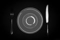 Cutlery, knife, fork and plate on black background Royalty Free Stock Photo