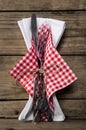 Cutlery with knife and fork plus a napkin in red white checked c Royalty Free Stock Photo