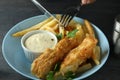 Cutlery over the fried fish and chips, close up Royalty Free Stock Photo