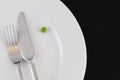 Cutlery and a pea on the plate Royalty Free Stock Photo