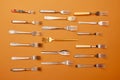 Cutlery. Pop art style. Top view flat lay photo of variety of stainless steel, antique silverware and gold forks Royalty Free Stock Photo