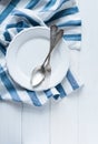 Cutlery, porcelain plate and white linen napkin Royalty Free Stock Photo