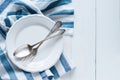 Cutlery, porcelain plate and white linen napkin Royalty Free Stock Photo