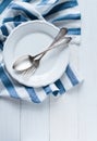 Cutlery, porcelain plate and white linen napkin Royalty Free Stock Photo