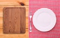 Cutlery red checkered tablecloth tartan on wooden Royalty Free Stock Photo