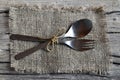 Cutlery set:fork and spoon on burlap cloth on rustic wooden table.Cutlery on old wooden background.Can be used as background menu Royalty Free Stock Photo