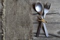 Cutlery set:fork and spoon on burlap cloth on rustic wooden table.Cutlery on old wooden background.Can be used as background menu Royalty Free Stock Photo