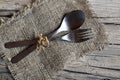 Cutlery set:fork and spoon on burlap cloth on rustic wooden table.Cutlery on old wooden background.Can be used as background menu Royalty Free Stock Photo