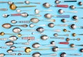 Cutlery. Top view photo of variety of antique silverware and gold kitchen spoons arranged against blue studio background