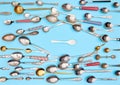 Cutlery. Top view photo of variety of antique silverware and gold kitchen spoons and one plastic spoon arranged against