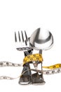 Cutlery wrapped with a tape measure, symbol for a diet Royalty Free Stock Photo