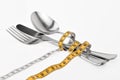 Cutlery wrapped with a tape measure, symbol for a diet Royalty Free Stock Photo