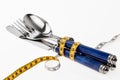 Cutlery wrapped with a tape measure, symbol for a diet Royalty Free Stock Photo