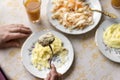 Cutlet on a fork in hand, mashed potatoes on a plate Royalty Free Stock Photo