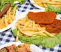 cutlets and French fries in the plate on the table Royalty Free Stock Photo