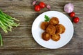 Cutlets. Juicy, golden fried cutlets in a ceramic plate on a wooden table.