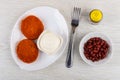 Cutlets, mayonnaise in dish, fork, pepper, bowl with red beans o