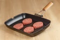 Cutlets in a pan on a wooden table