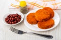 Cutlets in plate, fork, pepper, napkin, bowl with red beans on t