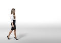 Cutout businesswoman in an office dress goes to side.