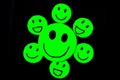 cutout of green emoticons with smiley face on black background. ll-being, good habits, health, personal care,