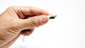 Closeup cut-out shot of a hand holding a USB wire on white background