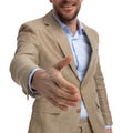 Cutout picture of businessman in beige suit shaking hand and welcoming