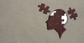 Cutout silhouette of a human head profile containing brain made from puzzle pieces craft paper jigsaw Royalty Free Stock Photo