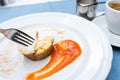 Cuts with a fork. Viennese Apple strudel with fruit sauce on a plate. not a classic shape in a unique way Royalty Free Stock Photo