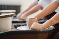 Cuts of product with wire. Craftsman hands making pottery bowl. Woman working on potter wheel. Family business shop Royalty Free Stock Photo