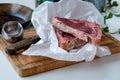 Cuts of raw beef on the cutting board with some green salad in t Royalty Free Stock Photo