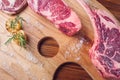 Cuts of raw steak premium on rustic wooden table. Fresh and raw meat. Raw meat mixture. Raw beef steaks on wooden table