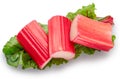 Cuts of red rhubarb on green rhubarb leaf on white background. File contains clipping path Royalty Free Stock Photo