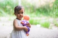 Cutte little girl with white dress hold her little baby doll in her arms