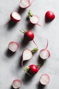 Cutted fresh radish on a white marble kitchen board.