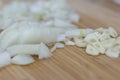 Cutted garlic and onios on a wooden background