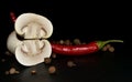 cutted mushroom  red hot pepper and allspice on a black background Royalty Free Stock Photo