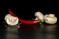 cutted mushroom red hot pepper on a black background