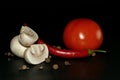 cutted mushroom  red hot pepper  tomato and allspice on a black background Royalty Free Stock Photo